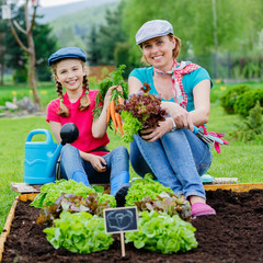 Gardening - girl with mother working in the garden © Gorilla