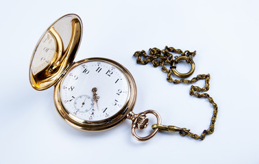 Gold pocket watch on white