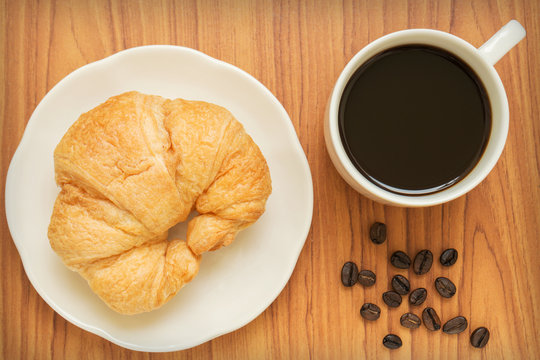 Coffee cup and croissant