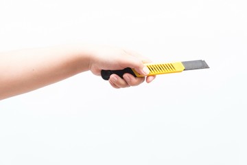Asian woman holding a yellow box cutter knife