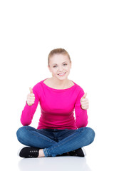 young casual woman student showin OK gesture.