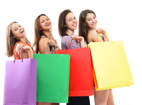 beautiful happy teen girls with colored shopping sale bags over