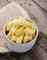 cut raw potatoes in bowl