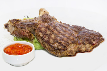 grilling steak with tomato sauce