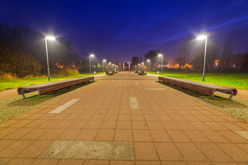 Park pathway in Pruszcz Gdanski at night, Poland