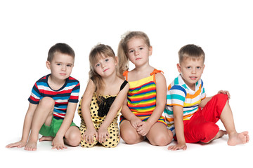 Four preschool children sit on the floor