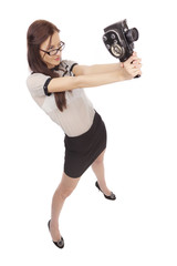 Girl with old movie camera on white background