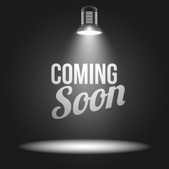 Coming soon message illuminated with light projector