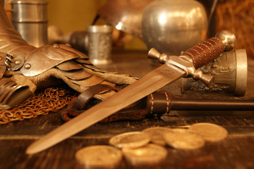 Medieval dagger on old table