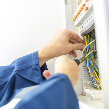 Electrician installing an electrical fuse box