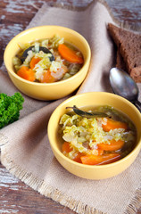 Cabbage, carrot and red lentil soup in bowls