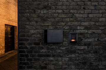 entry phone on old brick wall