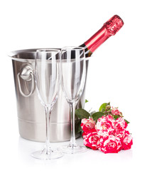 Champagne bottle, two glasses and red rose flowers