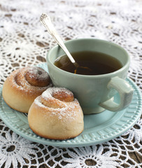 Fresh Sweet Homemade Cinnamon Rolls and Cup of Tea