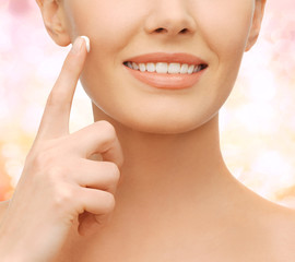 beautiful woman applying moisturizing cream