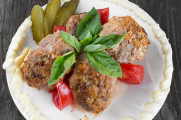 lula lamb and tomatoes on a plate