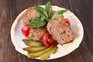 lula lamb and tomatoes on a plate