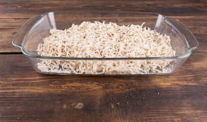 egg noodles raw in a glass bowl