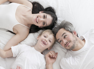 Lovely family lying in bed