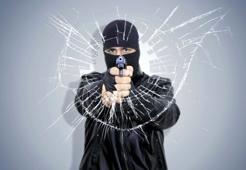Robber is shooting to glass
