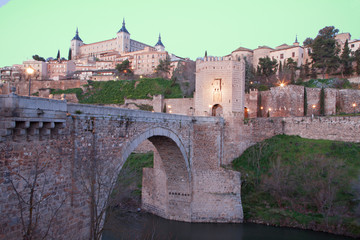 Toledo - Alcazar and Punte de Alcantara bridge in morning dusk