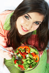 Young woman eat salad. Healthy vegetarian food.