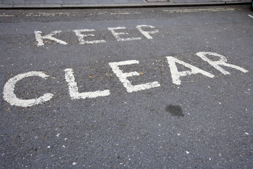 Fototapeta premium Close-Up of road marking saying Keep Clear in London, UK