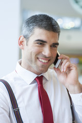 Close-up of businessman smiling on mobile phone