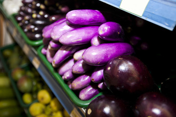 Variety of eggplants on display in grocery store