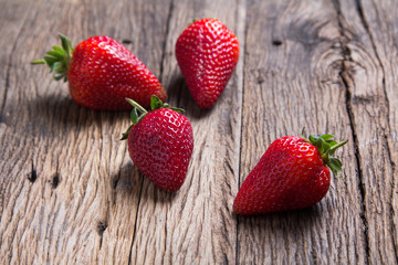 Fresh strawberries on old wooden background