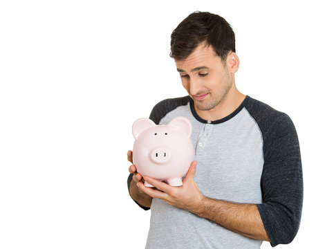 young successful, happy man, worker, holding piggy bank 