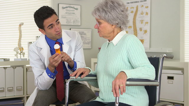 Mexican doctor explaining medication to elderly woman