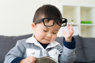 Asian boy wear glasses with mirror
