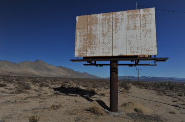 Old rusted blank billboard by road