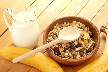 Plate with raw oatmeal on wooden table.