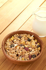 Plate with raw oatmeal on wooden table.