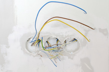 Fototapeta premium Undone AC power socket in wall. Repairs in the apartment.