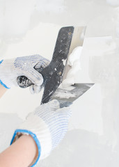Hands working with spackling paste