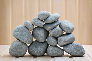 Sauna stones. Stacked on a wooden surface. Ready for heating.