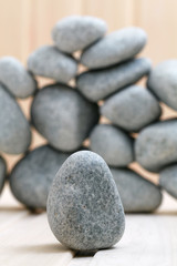 Sauna stones. Stacked on a wooden surface. Ready for heating.