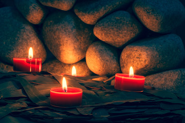 Candles are lit on the background of the sauna stones. Preparing