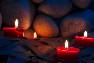 Candles are lit on the background of the sauna stones. Preparing