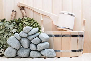 Broom, bucket, sauna stones and bath accessories.