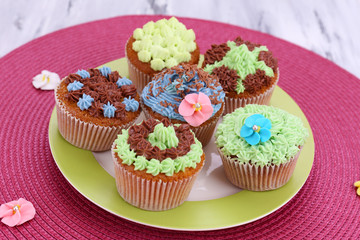 Tasty cupcakes with butter cream,