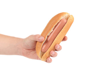 Hand hold uncooked hotdog.