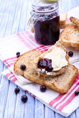 Delicious toast with jam on table close-up