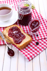 Delicious toast with jam on table close-up