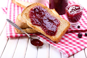 Delicious toast with jam on table close-up