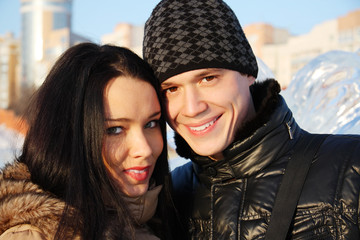 Fototapeta premium Young beautiful couple stand together and smile at winter