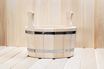 Fototapeta na wymiar Bucket for a bath on a wooden surface.